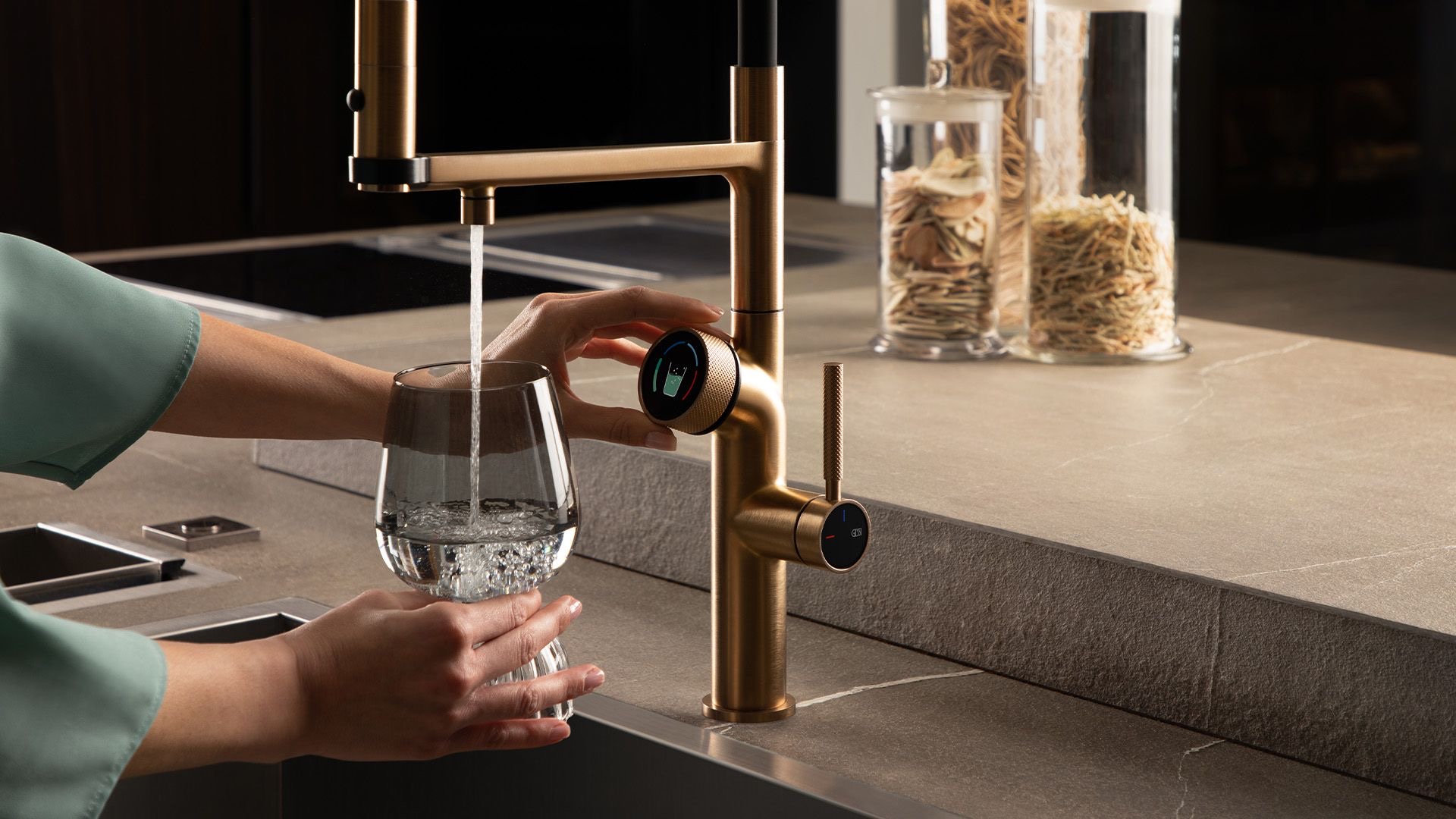 Gessi Vita tap pouring filtered water into a glass with the digital selector in view