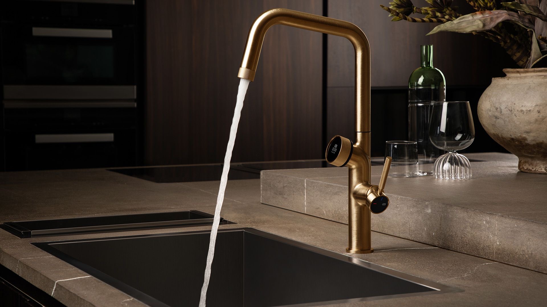 Gessi Vita tap with the display lit on a stone worktop in a contemporary kitchen