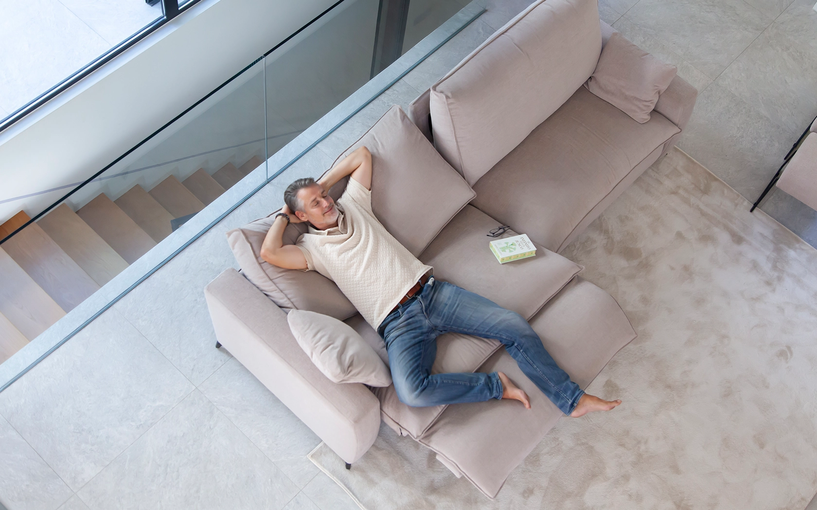 Two-seater Fama sofa upholstered in dusty pink with a deep seat and loose cushions, seen from above